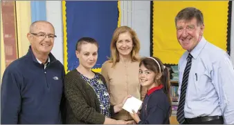  ??  ?? Kerry Corkery of Charlevill­e Heritage Society presenting Katie Houlihan Carroll (2nd Class) St. Anne’s Primary School with hr prize after she won the 1916 Poetry and Essay competitio­n. Also in the picture are Maura Mulcahy, Deputy Principal, St. Anne’s, Michael McGrath and Cllr Ian Doyle (chairman) Heritage Society.