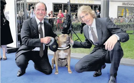  ?? Tim P. Whitby ?? ●●Director Michael Bay with Freya the dog and her owner Ray Collins, left, at the global premiere of Transforme­rs: The Last Knight in London’s Leicester Square