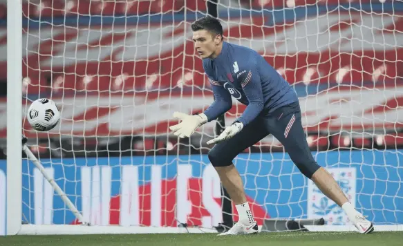  ??  ?? England’s goalkeeper Nick Pope warms up.