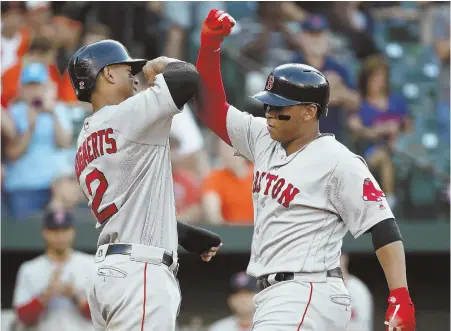  ?? AP PHOTO ?? STARTING IT OFF RIGHT: Rafael Devers (right) celebrates with Xander Bogaerts after his two-run home run in the second inning sent the Red Sox on their way to a 6-4 victory against the Orioles last night in Baltimore.