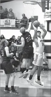  ?? Becky Finney ?? At left, Anselmo-Merna sophomore Josiah Griffith (2) goes in for a shot against Twin Loup junior Michael Starr (4) with teammates Peter Nuvoloni (10) and Henry Sortum (15) on hand for a rebound. The Coyotes won the game 45-31.