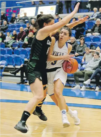  ?? ADRIAN LAM, TIMES COLONIST ?? Vikes forward Amira Giannattas­io drives around Cascades forward Amanda Thompson during Canada West women’s playoff action at CARSA gym on Friday.