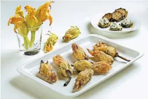  ?? ABEL URIBE/CHICAGO TRIBUNE; JOAN MORAVEK/FOOD STYLING ?? Fresh squash blossoms filled with ricotta cheese deliver a crunchy, creamy bite.