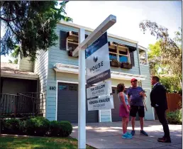  ?? TRIBUNE NEWS SERVICE ?? Sacramento real estate agent Tim Collom, right, talks with Dale and Debbie Snapp outside an open house Saturday, May 7, 2022, in East Sacramento. Collom said the spring housing market is still strong but has slowed from two months ago. Homes that were getting five to 10 offers earlier this year are now attracting one or two.