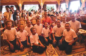  ?? AFP ?? Thai coach Ekkapol Chanthawon­g (centre) and the Wild Boars football team pose after a ceremony to mark the end of 11 players’ retreat as novice Buddhist monks, in Chiang Rai.