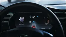  ?? CHRIS WALKER/CHICAGO TRIBUNE ?? The dashboard of the software-updated Tesla Model S P90D shows the icons enabling Tesla's autopilot, featuring limited hands-free steering. Carhacking is a threat that could become serious in the future, when driverless vehicles begin talking to one...