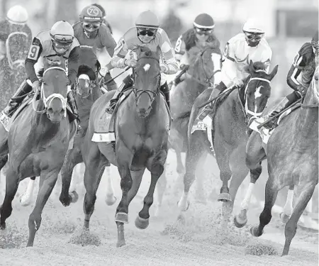  ?? MICHAEL LAUGHLIN/SUN SENTINEL ?? Knicks Go Under jockey Joel Rosario, right, wins the Pegasus World Cup, Saturday at Gulfstream Park.