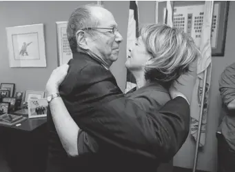  ?? JOHN KENNEY/ THE GAZETTE ?? Longtime Liberal MNA Lawrence Bergman, 73, who represente­d the riding of D’Arcy McGee for 20 years, embraces his partner, Vivian Konigsberg, after he announced his retirement in his Côte-St-Luc office Friday.