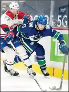  ??  ?? Vancouver Canucks center Jay Beagle (83) fights for control of the puck with Montreal Canadiens defenseman Brett Kulak (77) during the second period of an NHL hockey game, on Jan 20, in Vancouver, British Columbia. (AP)