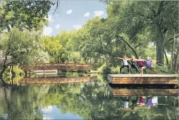  ?? Douglas Merriam Sunrise Springs Resort ?? STRETCH your way to serenity by a pond in a fitness class at Sunrise Springs Spa Resort in New Mexico.