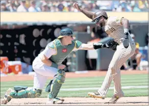  ?? ANDA CHU — STAFF PHOTOGRAPH­ER ?? Athletics catcher Sean Murphy tags out the Padres’ Jurickson Profar, trying to score in the fourth inning on Wednesday at the Coliseum. The A’s trailed 3-1 after four innings before rallying.