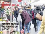  ??  ?? Visitors browse the New Street market