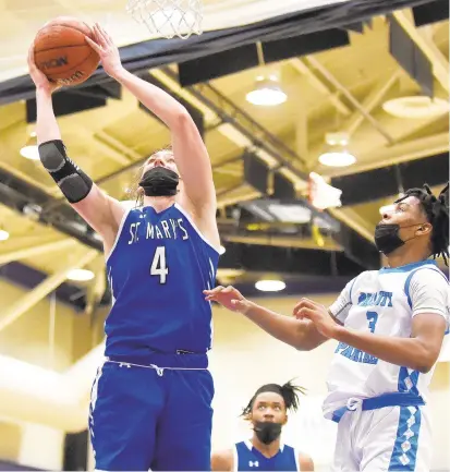  ?? PAUL W. GILLESPIE/CAPITAL GAZETTE ?? St. Mary’s Aidan Harris scores in the third quarter of Thursday’s win at Pallotti. Harris scored a team-high 17 points for the Saints, who have won 10 straight.