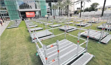  ?? RICARDO RAMIREZ BUXEDA/ORLANDO SENTINEL ?? Outdoor, distanced boxes are set up for guests to enjoy performanc­es at the Frontyard Festival at the Dr. Phillips Center for the Performing Arts.