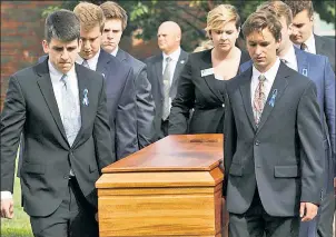  ??  ?? SAD: Grim-faced pallbearer­s carry Otto Warmbier’s (inset) coffin Thursday from his Ohio school.