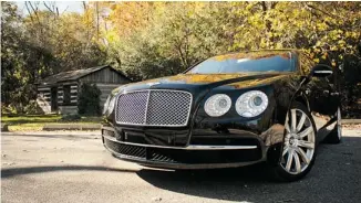  ?? DAVID BOOTH/POSTMEDIA NEWS ?? The 2014 Bentley Flying Spur — with rims the size of manhole covers — floats serenely over the worst roads.