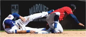  ?? MATT MARTON/AP ?? David Bote was tagged out by the Braves’ Ozzie Albies while trying to steal to end the sixth inning.