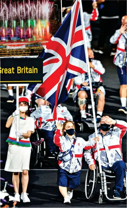  ??  ?? Our Great British flagbearer­s: Swimmer Ellie Simmonds, 26, and archer John Stubbs, 56, represente­d the 227-strong Team GB squad at the opening ceremony in Tokyo yesterday