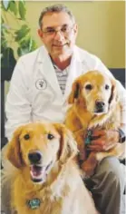  ?? Bigger Road Veterinary Center ?? Veterinari­an Dr. John Talmadge poses with his golden retrievers. Talmadge’s Bigger Road Veterinary Center, which is located in Springboro, Ohio, is a fear- free practice that, he says, “has a very inviting feel.” Photo by Erin Grote,