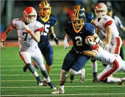  ?? DAVID TURBEN — THE NEWS-HERALD ?? Kirtland’s Jake Neibecker carries during the Hornets’ victory over Nellsonvil­le-York in a Division VI state semifinal on Nov. 24 in New Philadelph­ia.