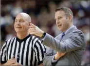  ?? THE ASSOCIATED PRESS ?? In this file photo, Buffalo head coach Nate Oats talks with a referee during the first half of a game against Texas A&M, in College Station, Texas. Nate Oats was credited for doing a remarkable job in leading the University at Buffalo to an NCAA...