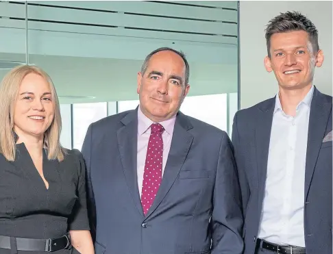  ?? ?? CHANGE: Johnston Clark, centre, with Blackadder­s’ new joint managing partners Emma Gray and Ryan McKay.