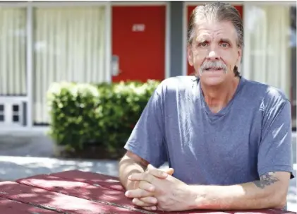  ?? STAFF PHOTO BY C.B. SCHMELTER ?? Mike “Boogie” Gilbert poses in a common area outside of his motel room on Wednesday in Dalton, Ga. Gilbert was displaced after an EF3 tornado tore through Murray County on Easter.