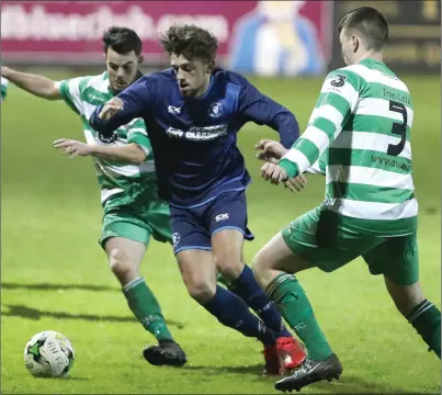  ??  ?? Boyne Harps’ Stephen Carter looks to get past Trim’s Sean Fitzgerald during last Thursday’s clash.