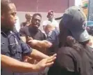  ??  ?? A video screengrab of Baltimore police officers arresting an alleged drug dealer as a crowd forms around them. Bystanders scream, and the officers request help.