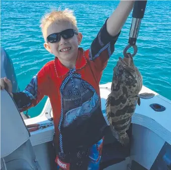  ??  ?? Darcy Easton with a 48cm rock cod caught in Darwin Harbour