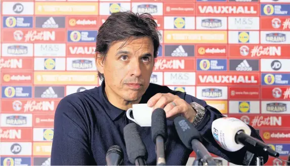  ??  ?? > Chris Coleman, pictured at a Wales press briefing this week, has revealed how he gave his father a traditiona­l Dublin send-off with a pint of Guinness