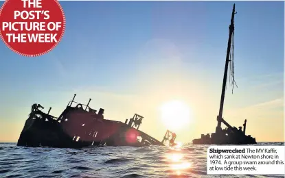  ??  ?? The MV Kaffir, which sank at Newton shore in 1974. A group swam around this at low tide this week. Shipwrecke­d