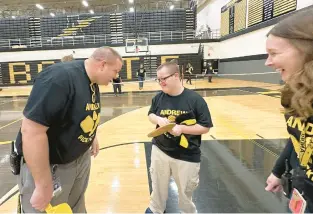  ?? SCHOOL DISTRICT 230 ?? Students at Andrew High School in Tinley Park join students from the school’s Ultima Program to try out new pickleball paddles they created in the school’s workshop.