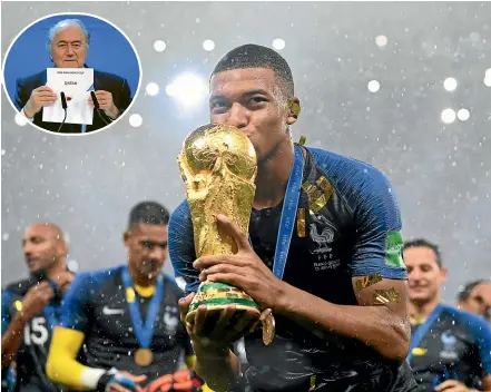  ?? GETTY IMAGES, AP ?? France’s Kylian Mbappe kisses the World Cup trophy after winning the 2018 tournament in Russia. Inset: Former Fifa boss Sepp Blatter reveals Qatar as hosts of the 2022 World Cup after a vote in Zurich in 2010.