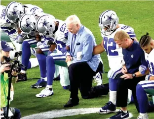  ?? Associated Press file photo ?? The Dallas Cowboys, led by owner Jerry Jones, center, take a knee prior to the national anthem before an NFL football game on Sept. 25 against the Arizona Cardinals in Glendale, Ariz. What began more than a year ago with a lone NFL quarterbac­k...