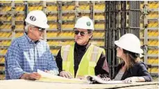  ?? D.E. Harvey Builders ?? David Harvey Jr., Charles Overman and Catherine Linhart confer on a project.
