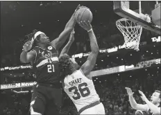  ?? CHARLES KRUPA/AP ?? MILWAUKEE BUCKS GUARD JRUE HOLIDAY (21) blocks a shot by Boston Celtics guard Marcus Smart (36) in the final seconds of play during the second half of Game 5 of an Eastern Conference semifinal in the playoffs on Wednesday in Boston. The Bucks won 110-107.