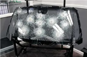  ??  ?? Texas Armoring Corporatio­n displays a showroom floor exhibit of a bulletproo­f windshield. Bulletproo­fing a vehicle costs tens of thousands of dollars.