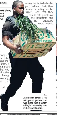  ?? FILE ?? A policeman carries a box with ground produce that was seized from a vendor selling in a no-vending area in downtown Kingston. Beckford Street was filled with shoppers and vendors on a recent STAR visit to downtown Kingston.