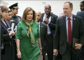  ?? J. SCOTT APPLEWHITE — THE ASSOCIATED PRESS ?? Speaker of the House Nancy Pelosi, D-Calif., joined by House Intelligen­ce Committee Chairman Adam Schiff, D-Calif., leaves a closed-door meeting with the Democratic Caucus on Tuesday at the Capitol in Washington, .