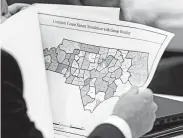  ?? Associated Press file photo ?? A lawmaker studies a map in Raleigh, N.C., in 2017. A new round of redistrict­ing for the U.S. House and state legislatur­es will occur after the 2020 census.