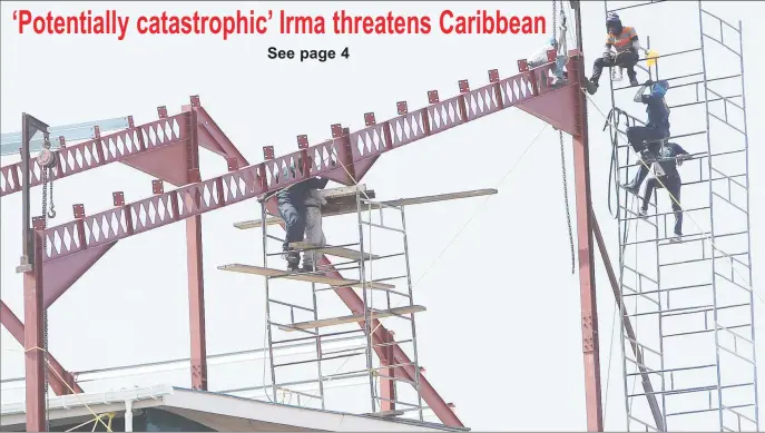  ??  ?? Not safe:
While the Guyana Revenue Authority works to make their Camp Street Headquarte­rs safer for their staff, the labourers are functionin­g in unsafe conditions. In this Keno George photo, workers at the site balance several hundred feet in the air...