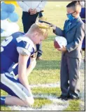  ??  ?? King Bryson Funk (left) bows down to receive his crown from Jacob Hernandez during the 2020 Decatur homecoming coronation ceremony at Bulldog Stadium in Decatur on Sept. 25.
(NWA Democrat-Gazette/Mike Eckels)