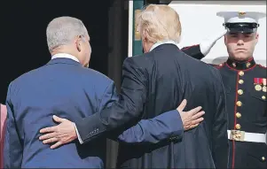  ??  ?? U.S. President Donald Trump escorts Israeli Prime Minister Benjamin Netanyahu into the White House in Washington, Wednesday.