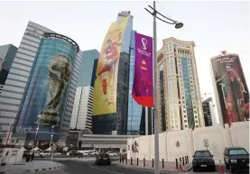  ?? Images /Getty ?? Images of Gareth Bale of Wales, Hassan Al-haydos of Qatar and the Fifa World Cup trophy are seen on sky scrapers in the West Bay area ahead of the World
Cup Qatar 2022 in Doha.