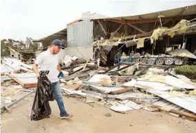  ??  ?? A limpiar. Miguel Debernardi­s retira los escombros de otro sitio afectado por el paso de Harvey, en Katy, Texas.