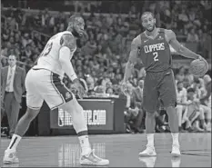  ?? Harry How Getty Images ?? LeBRON JAMES played determined defense against Kawhi Leonard and the Clippers on Sunday and is locking down more opponents.