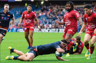  ??  ?? Captain Stuart McInally powers over the line to secure Edinburgh’s third try at Murrayfiel­d yesterday