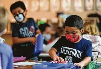  ?? Jason Fochtman / Staff photograph­er ?? Kindergart­ner Joel Salazar wears a face mask as he works at his desk at William Lloyd Meador Elementary School. Students in Willis ISD returned to in-person school on Sept. 8.