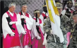  ?? Jacqueline Larma ?? The Associated Press Men wear crowns and hold unloaded weapons at the World Peace and Unificatio­n Sanctuary in Newfoundla­nd, Pa., on Wednesday. Worshipper­s brought their AR-15 rifles to a commitment ceremony at the church.